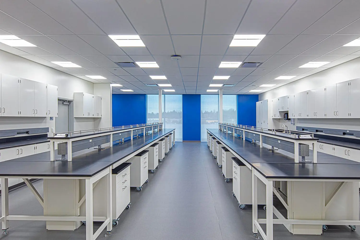Teaching laboratory with white casework and blue accent panels at BCIT Health Sciences Centre