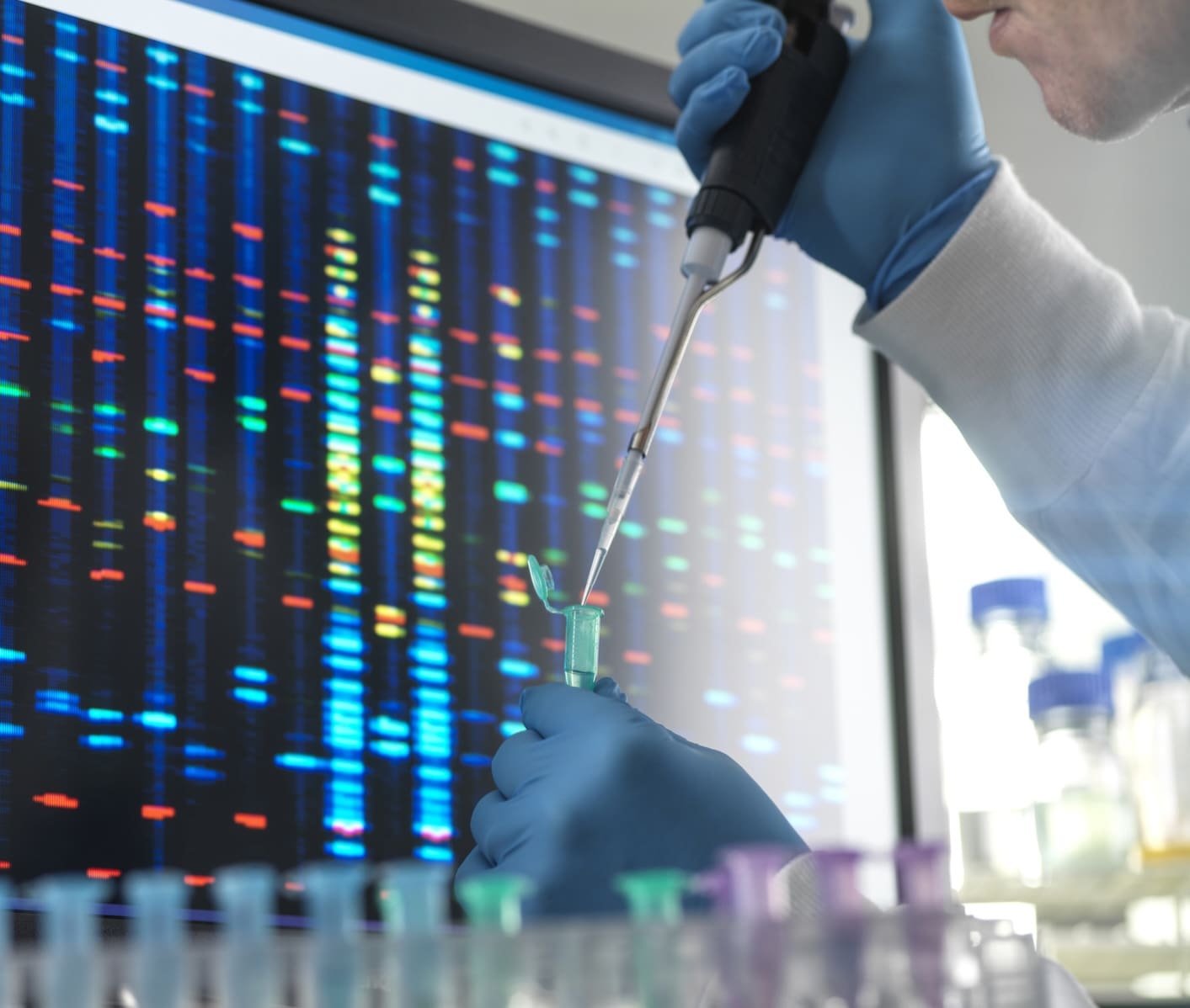 Scientist pipetting a DNA sample into a vial ready for testing