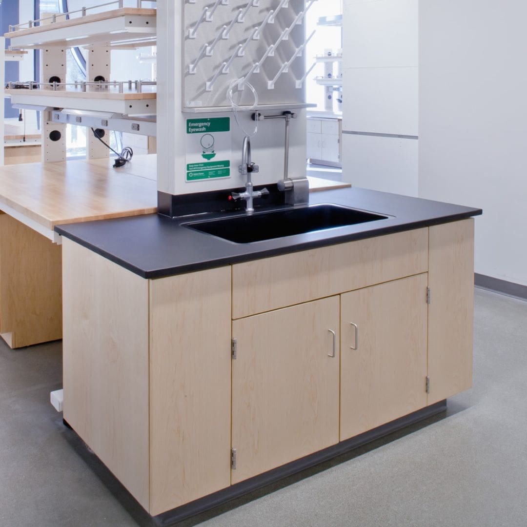 Laboratory island bench with an epoxy resin work surface and reagent shelf